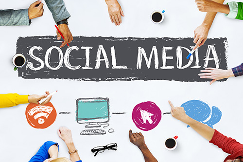 Social Media "Social Media" spelled out in an artistic canvas with multiple people adding images