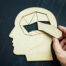 Human brain represented by puzzle pieces.
