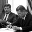 Black and white photo of Robert McNamaara and John F. Kennedy meeting about the Cuban Missile Crisis