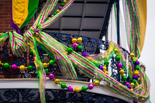 MardiGras Image of a balcony decorated for Mardi Gras with banners and baubles