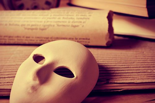 playwriting Image of a theatre mask in front of sheets of paper