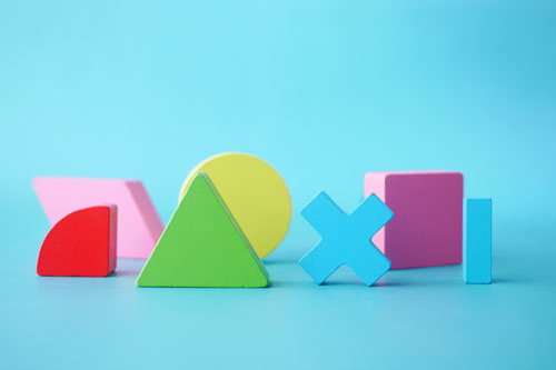 Photo of several colorfully shaped blocks on a blue background