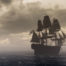 large Pirate style ship along the a gray horizon line in the ocean