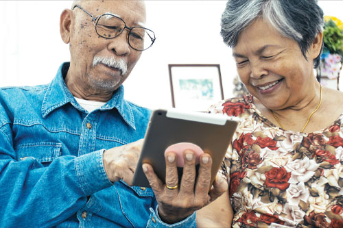Two people reading on a tablet