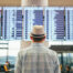 Man looking at list of flights in an airport