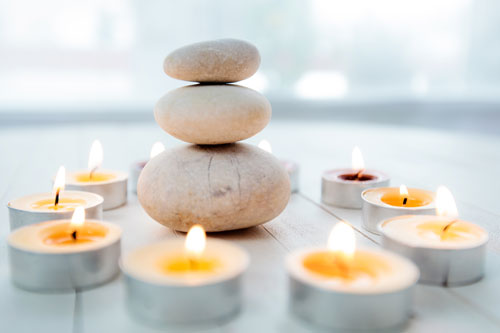 Stacked stones and candles crwating a meditative scene
