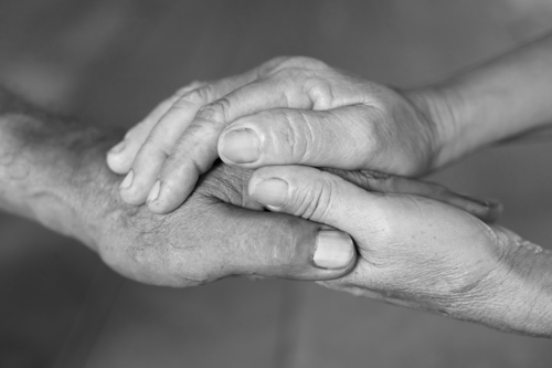 Two people holding hands