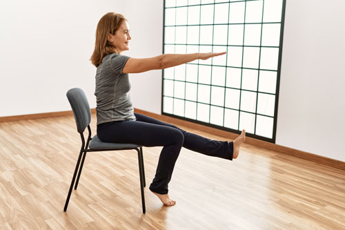 Woman doing yoga in a chair